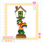 a card with a picture of a house and a rainbow