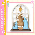 A wooden nativity scene depicting the birth of Jesus Christ, with the Virgin Mary kneeling and the baby Jesus in the manger.