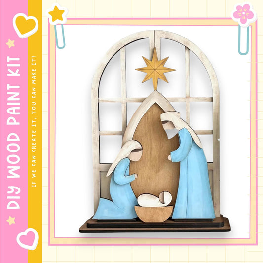 A wooden nativity scene depicting the birth of Jesus Christ, with the Virgin Mary kneeling and the baby Jesus in the manger.