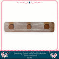 a wooden shelf with three circular holes on it, placed against a white background.