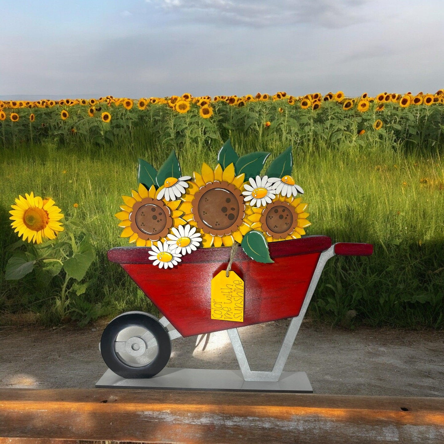 a red wheelbarrow with sunflowers and cookies on it