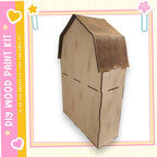 A wooden house kit with a brown roof and a heart-shaped cutout on the side, displayed against a pink and yellow background.