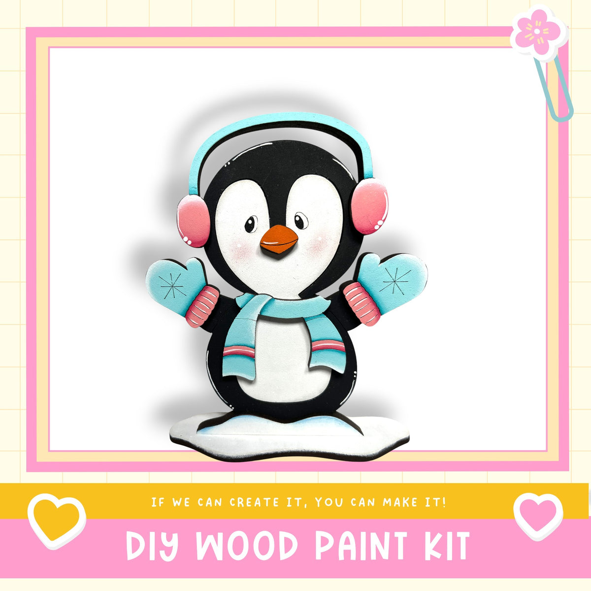 A wooden penguin figurine wearing headphones and a scarf, with the text "DIY WOOD PAINT KIT" and "If we can create it, you can make it!"