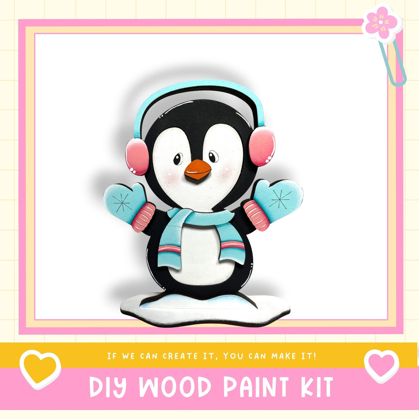 A wooden penguin figurine wearing headphones and a scarf, with the text "DIY WOOD PAINT KIT" and "If we can create it, you can make it!"