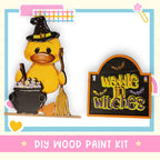 a yellow duck with a witches hat and broom