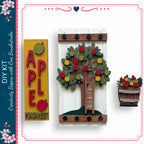 a DIY kit for creating a wooden sign with a tree design and a wooden barrel with a tree design. The kit includes a wooden sign with the word "APPLE" and a wooden barrel with a tree design.