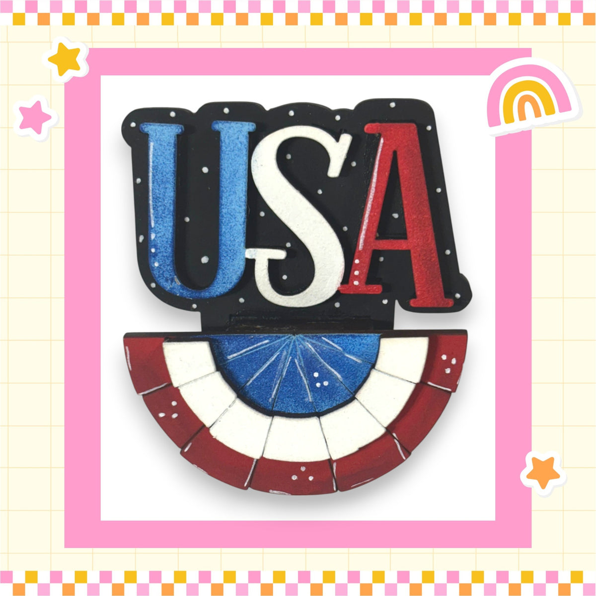 a patriotic design with the word "USA" prominently displayed in the center, surrounded by a decorative border. The design includes a flag-like shape and a fan-like shape, both in red, white, and blue colors. The background of the image is pink and yellow, creating a cheerful and festive atmosphere.