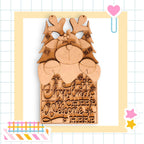 A wooden Christmas decoration with a reindeer and snowflakes, featuring the text "Christmas cheer welcome here" carved into it.