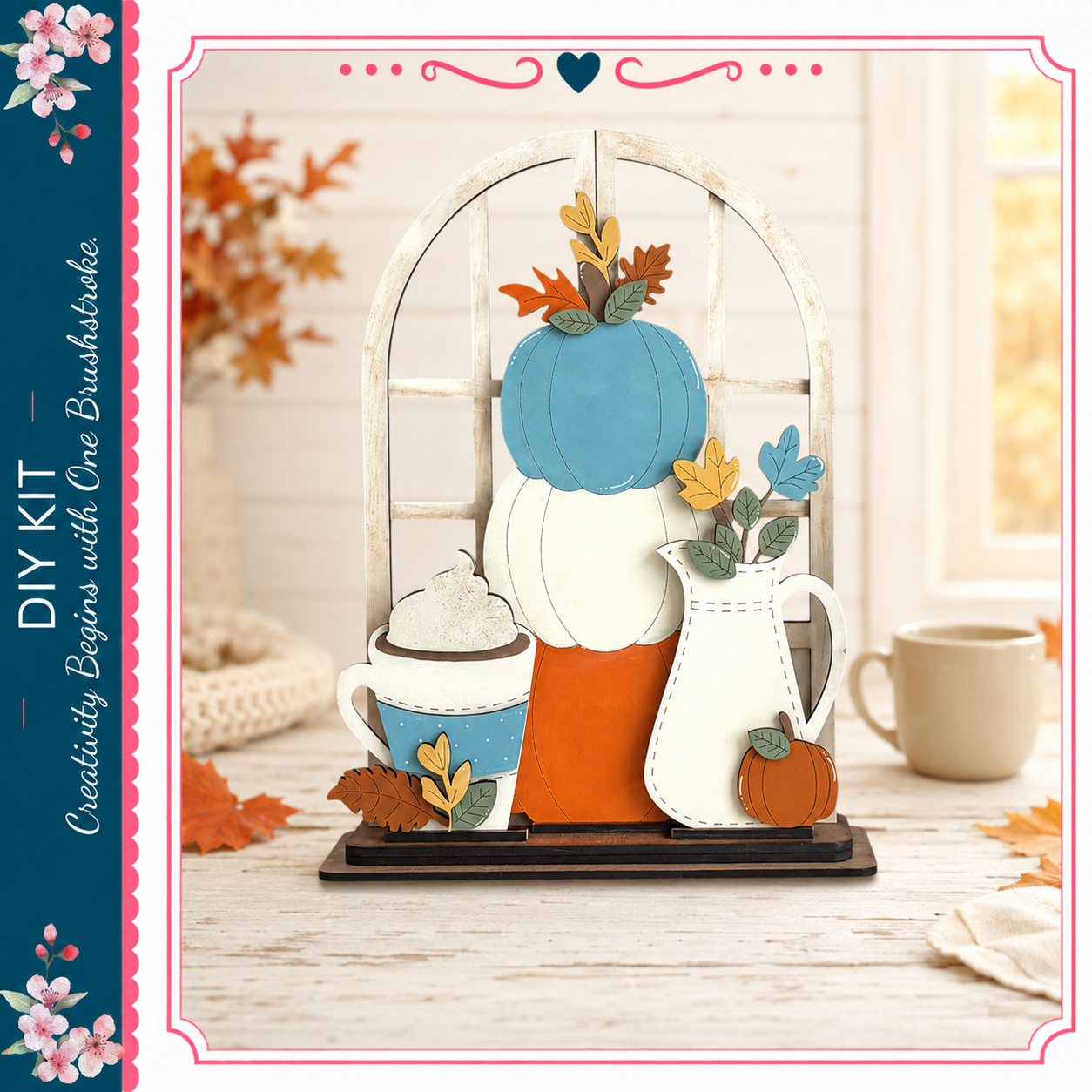 A DIY kit featuring a wooden frame with a pumpkin, a teapot, and a vase, set against a backdrop of autumn leaves and flowers.