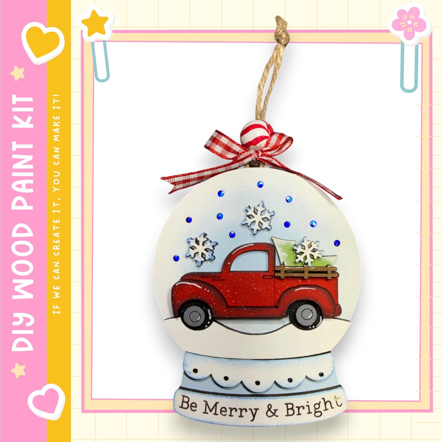 A snow globe ornament with a red truck and snowflakes, hanging on a string.