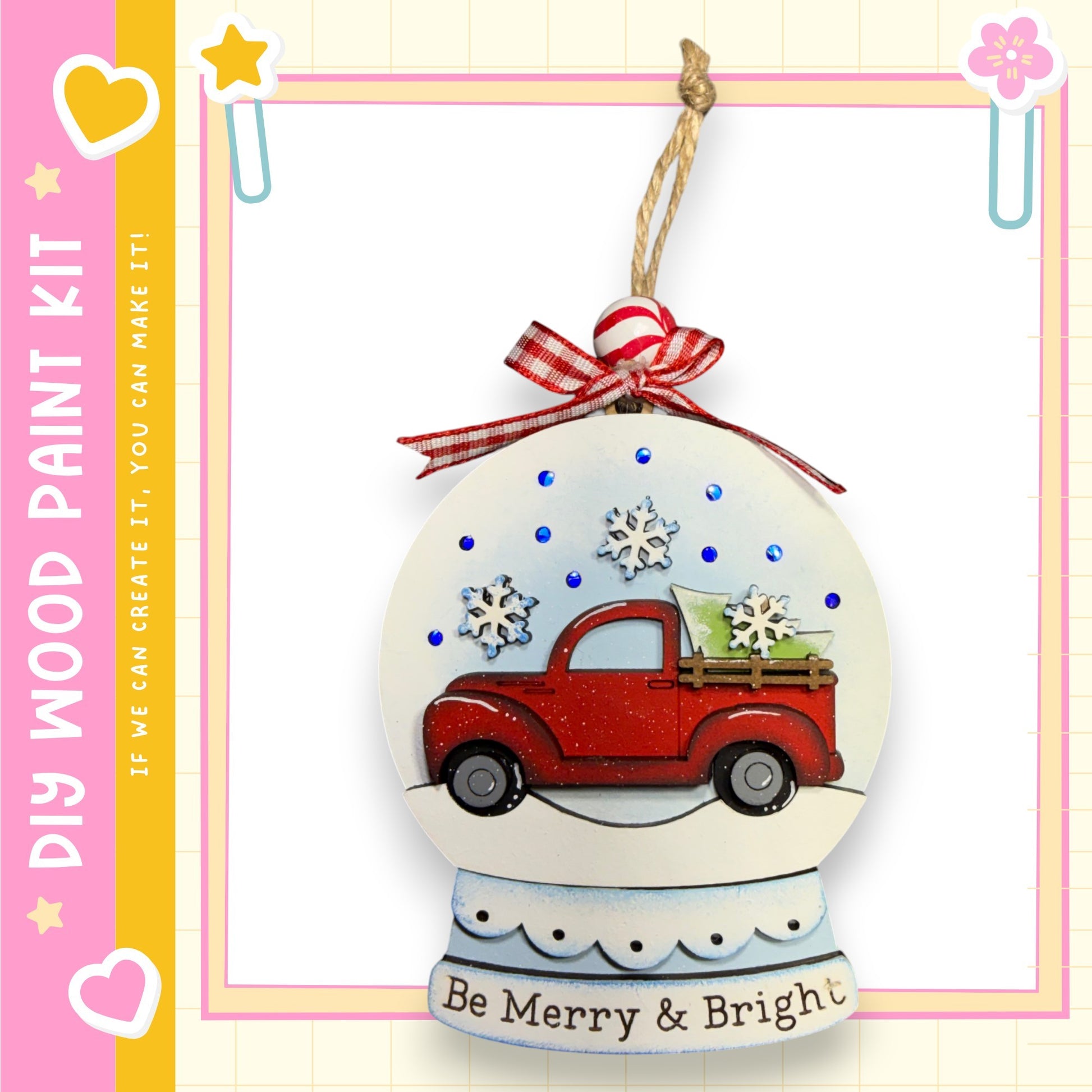 A snow globe ornament with a red truck and snowflakes, hanging on a string.