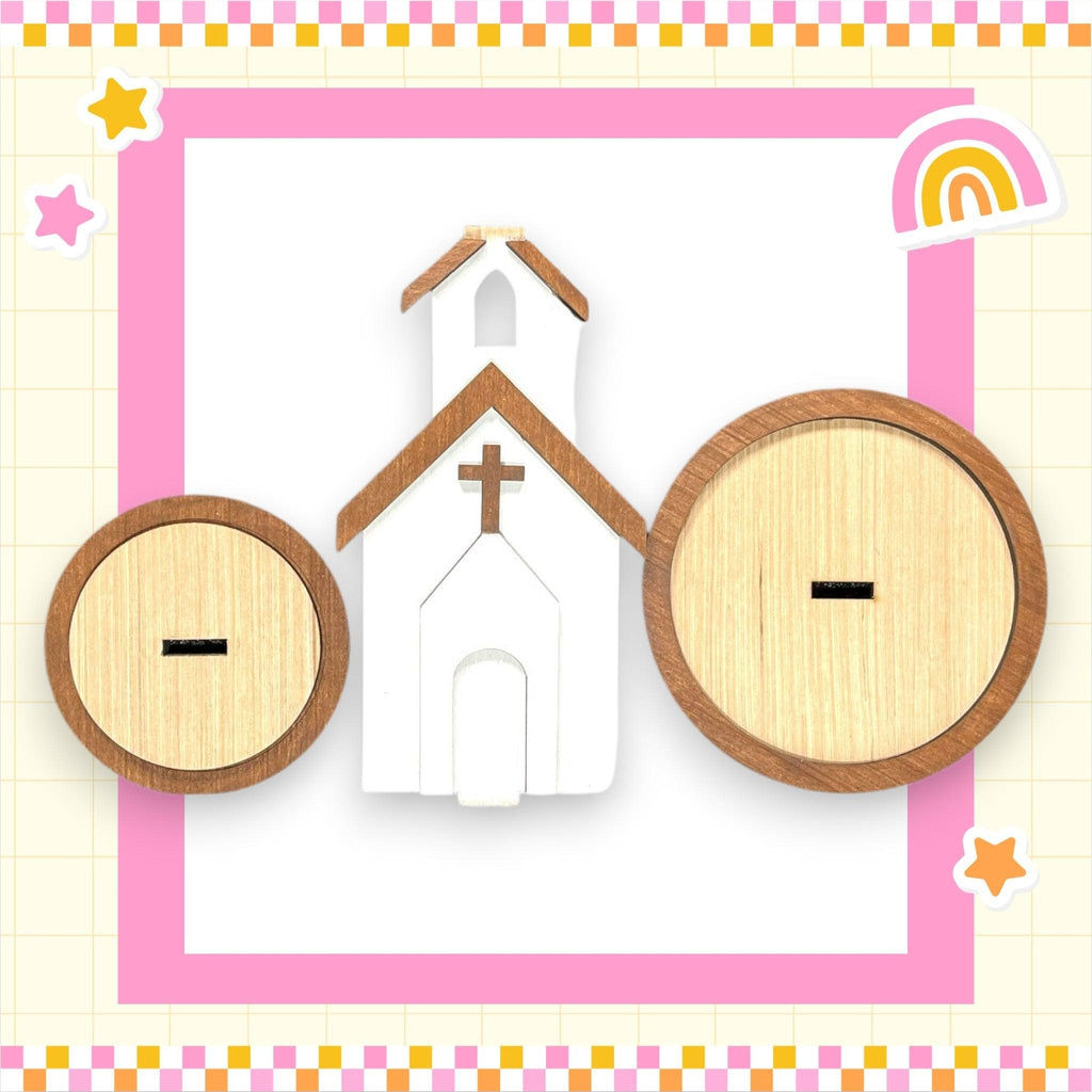 a wooden cutout of a church with a rainbow in the background