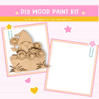 The image is a DIY wood paint kit with a wooden gnome and flowers, along with a blank frame.