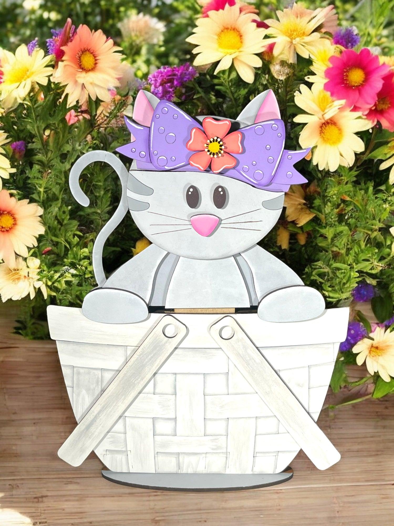 a paper cutout of a cat sitting in a basket