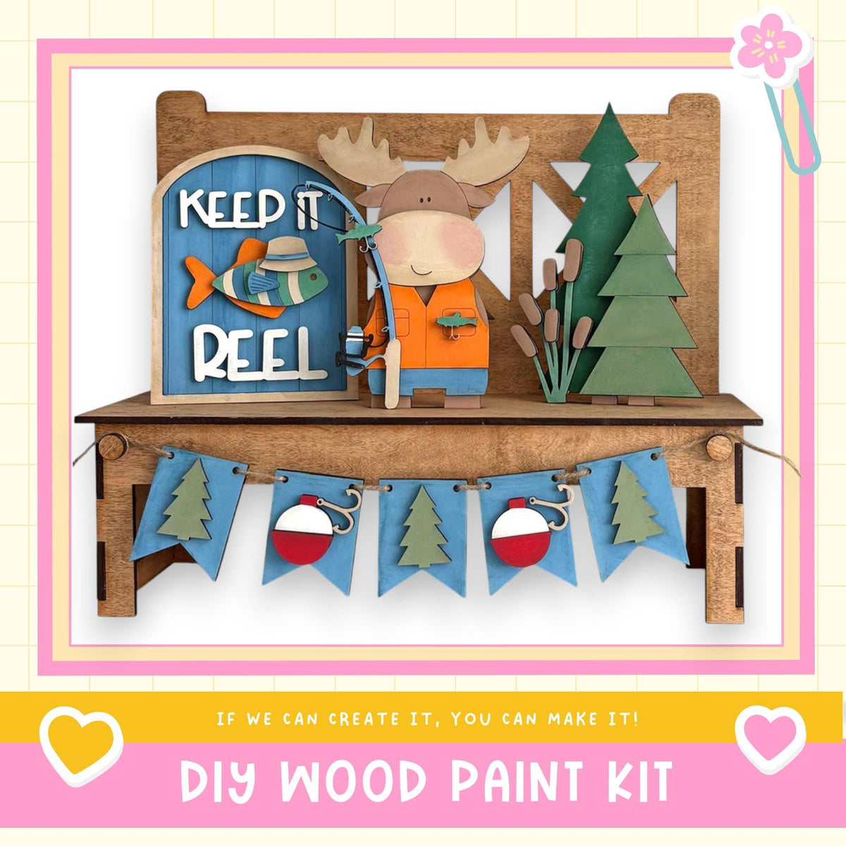 A DIY wood paint kit featuring a moose figure, a fishing sign, and a garland of flags. The kit appears to be made of wood and is designed for creating custom wooden decorations.