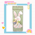 a card with a picture of a bunny holding a basket of flowers