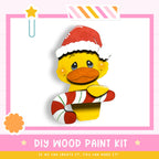 A cheerful yellow duck wearing a Santa hat and holding a candy cane, with a pink and white striped border and a star decoration.