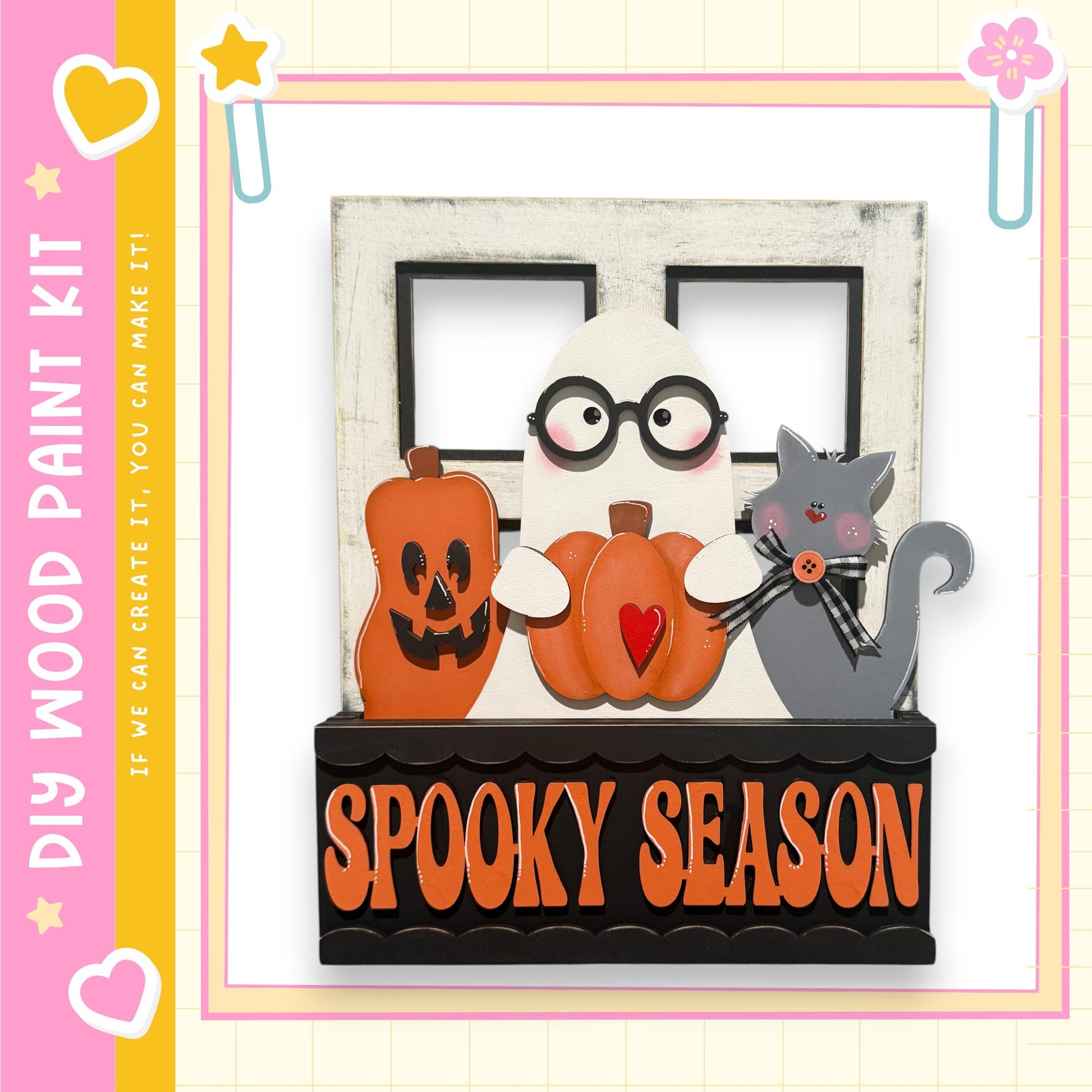 A spooky-themed wooden paint kit featuring a ghost, a cat, and pumpkins, with the text "SPOOKY SEASON" displayed on the kit.