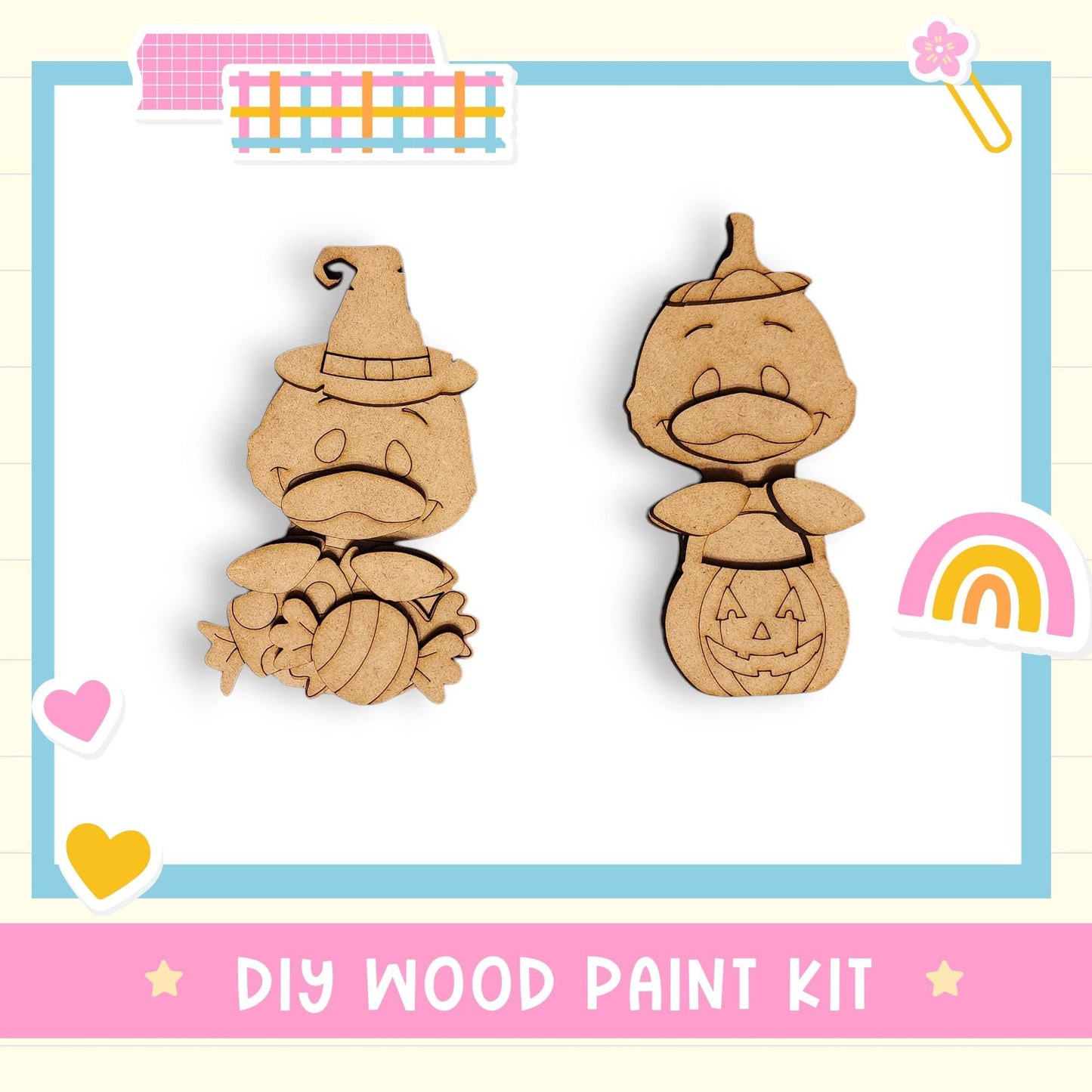 The image is a DIY wood paint kit featuring two wooden characters, a witch and a pumpkin, with a rainbow and hearts as decorative elements.