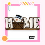 A snowman is sitting in a basket, with the word "HOME" displayed in a wooden frame.