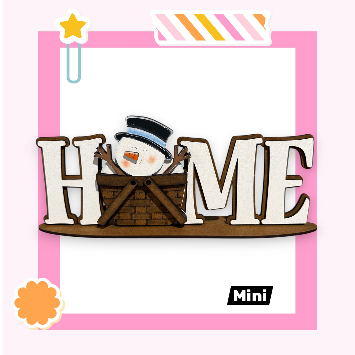 A snowman is sitting in a basket, with the word "HOME" displayed in a wooden frame.