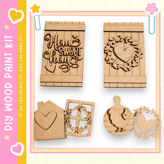 various wooden cutouts and decorations, including a heart-shaped cutout, a wreath cutout, and other wooden shapes, all of which appear to be part of a DIY paint kit for creating home-themed decorations.