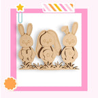 a wooden cutout of a family of rabbits