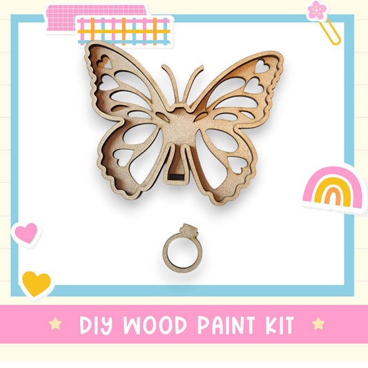 a wooden cutout of a butterfly with a rainbow in the background