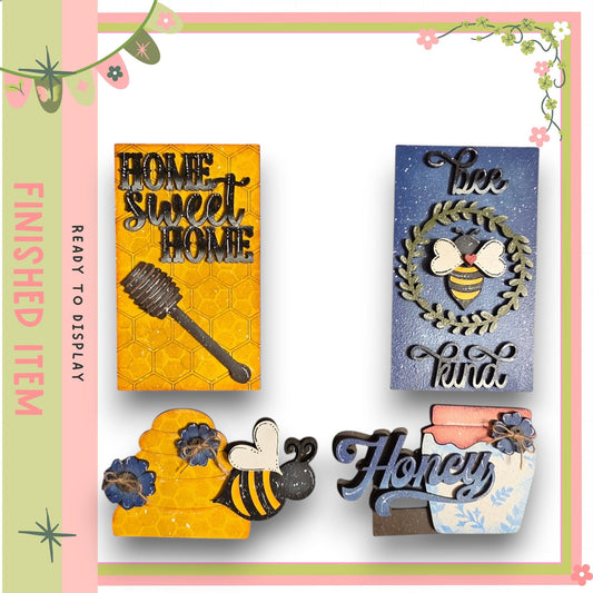 various decorative items, including a honeycomb-shaped piece, a honey jar, and a sign with the word "Honey".