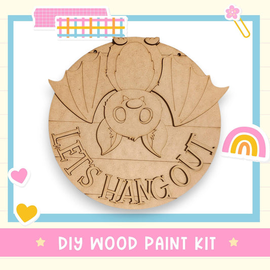 A DIY wood paint kit featuring a wooden bat with the text "LET'S HANG OUT" carved into it.