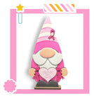 a pink and white gnome with a heart
