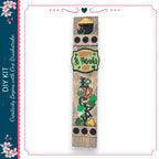 A vertical wooden sign with a happy St. Patrick's Day message and various decorative elements, including a pot of gold, shamrocks, and a horseshoe.
