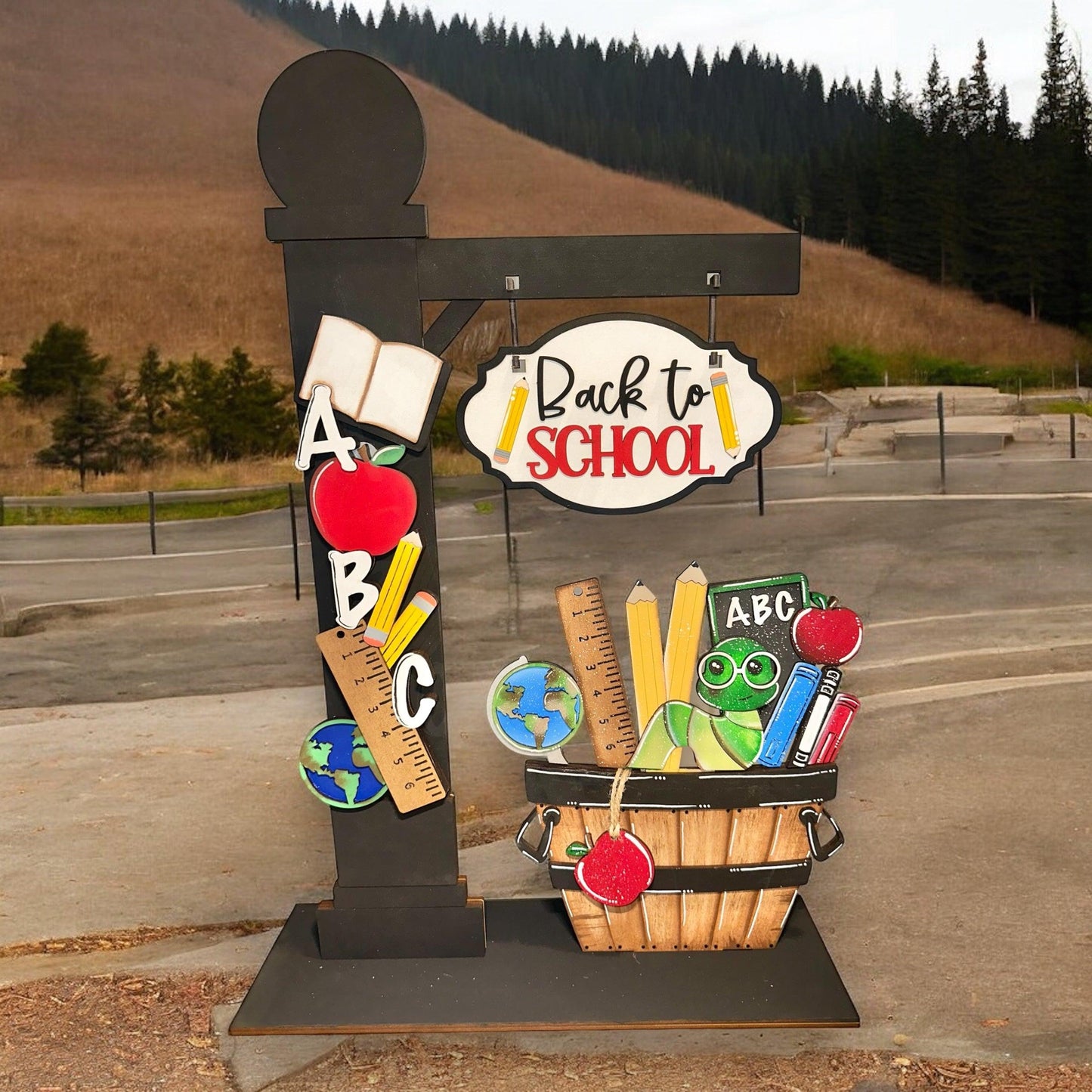 a school sign with a basket of school supplies