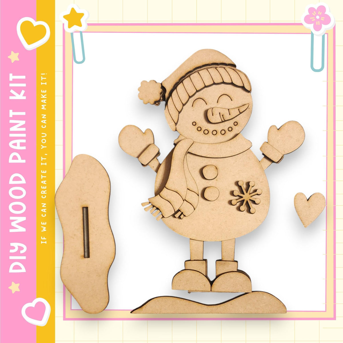 A wooden snowman kit with a smiling face, a carrot nose, and a scarf, along with a wooden stick and a heart-shaped cutout.