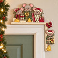 A festive holiday scene featuring a group of cartoon mice decorating a shelf with presents and cheese.