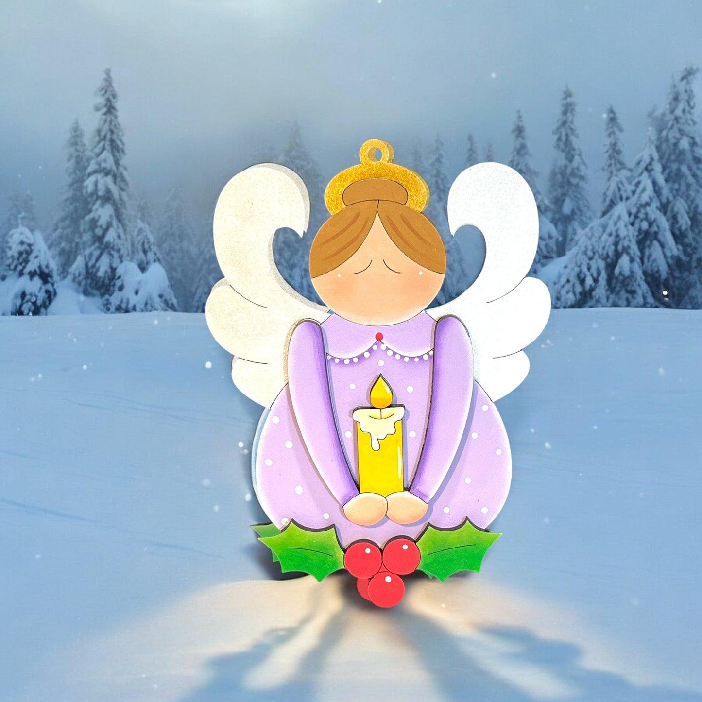 a christmas card with an angel holding a candle