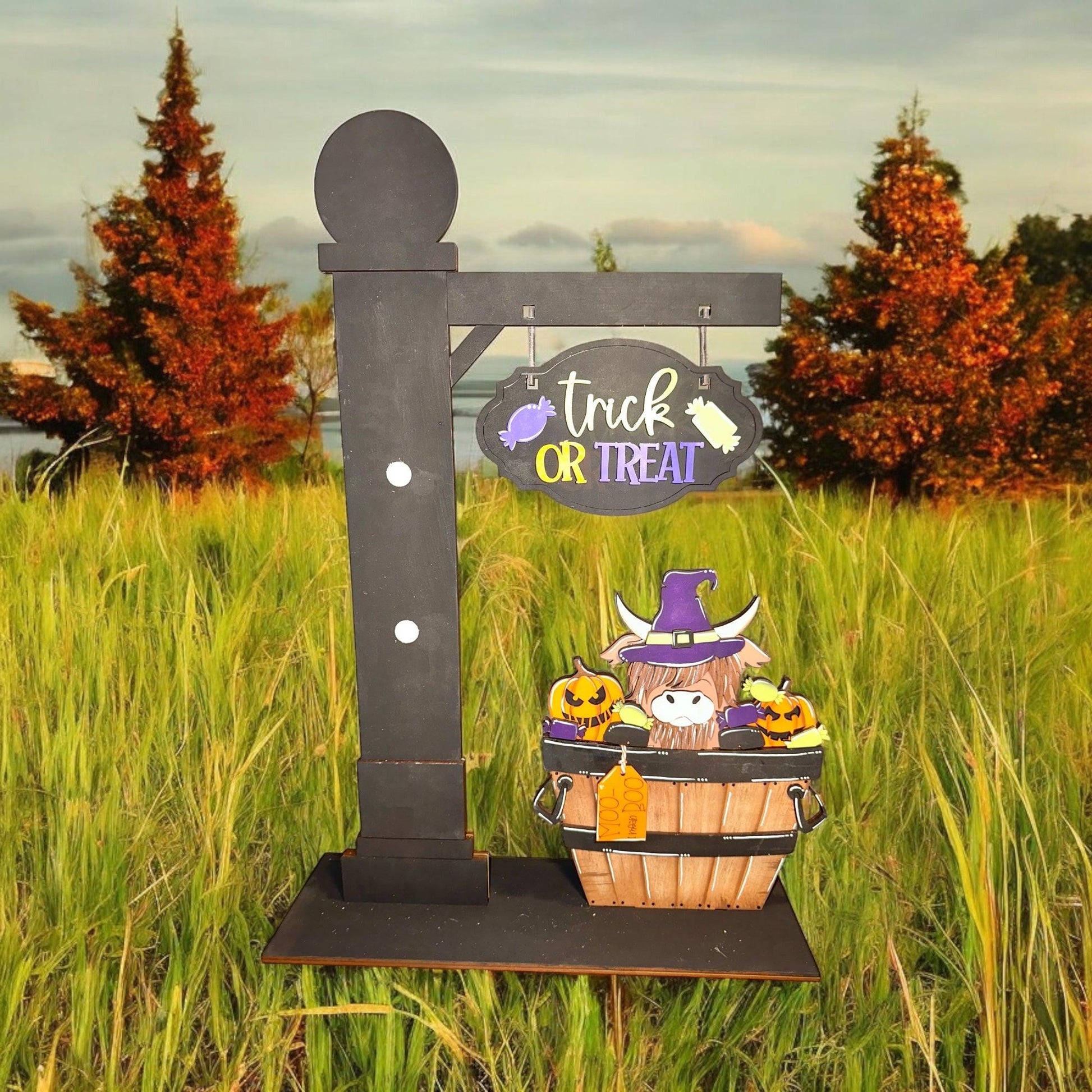 a trick or treat sign in the middle of a field