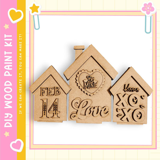 three wooden houses with various decorative elements, including hearts and text, arranged against a pink and yellow background.