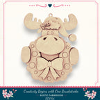 A wooden ornament in the shape of a moose wearing a wreath and a bow, with the caption "Creativity Begins with One Brushstroke. Rustic Farmhouse DIY Kit"