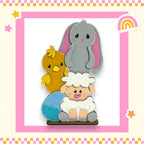 A colorful illustration featuring a gray rabbit, a yellow chick, and a white sheep, all sitting together in a playful arrangement.