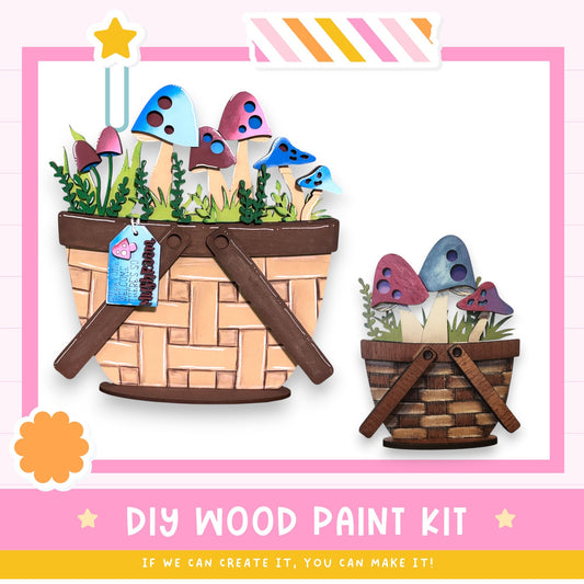 The image is a DIY wood paint kit featuring two baskets filled with mushrooms and plants, along with a star and a label. The text below the image encourages viewers to create their own artwork using the kit.