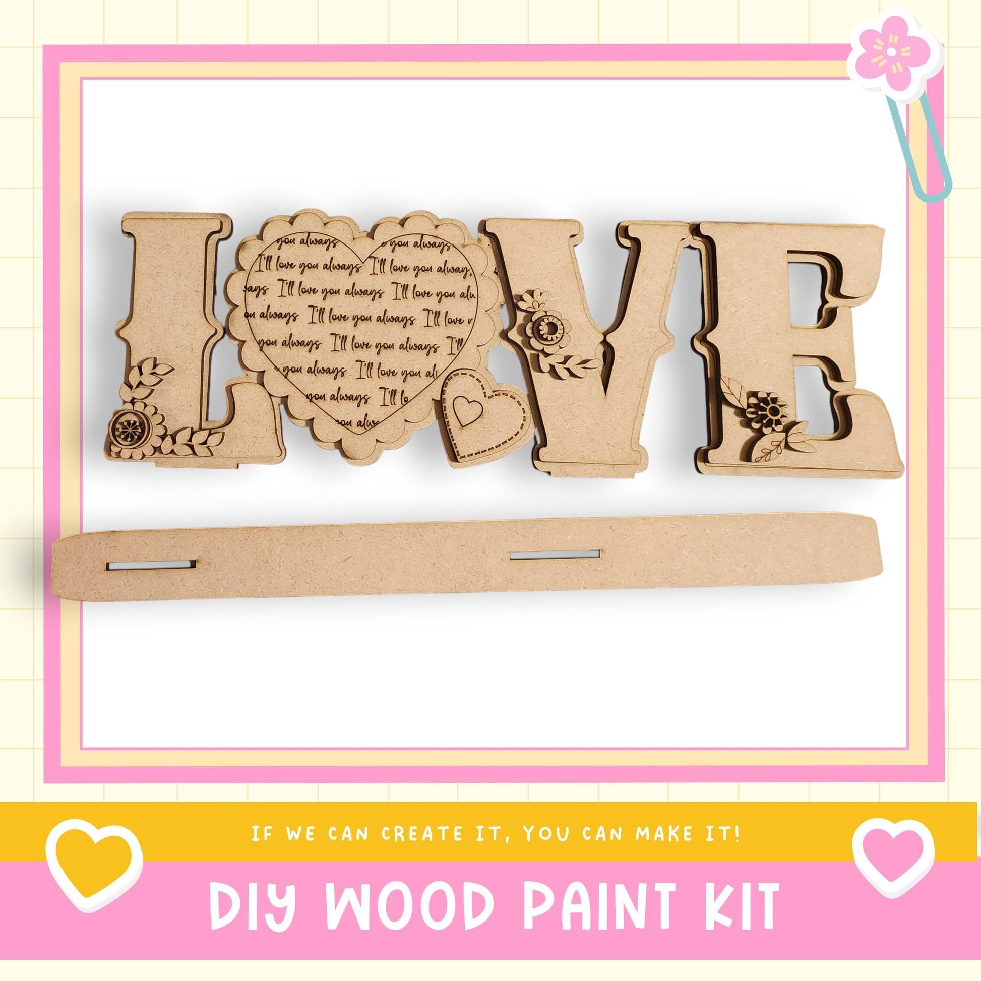 a DIY wood paint kit with the word "LOVE" made of wooden letters, along with a heart-shaped cutout and decorative elements.