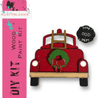 a red wooden toy car with a wreath on it