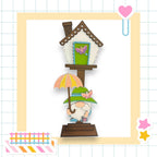 a card with a gnome holding an umbrella