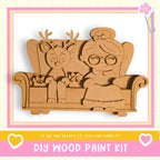 A DIY wood paint kit featuring a wooden reindeer and a wooden girl sitting on a wooden chair.