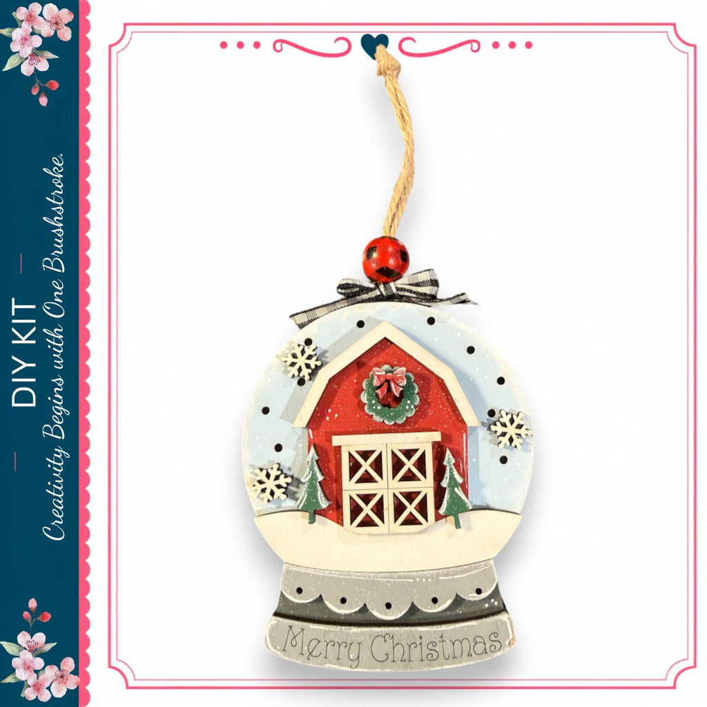 A decorative ornament in the shape of a snow globe, featuring a red barn, trees, and snowflakes. The ornament has a red ribbon and a red ball at the top. The text "Merry Christmas" is displayed on the ornament.