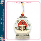 A decorative ornament in the shape of a snow globe, featuring a red barn, trees, and snowflakes. The ornament has a red ribbon and a red ball at the top. The text "Merry Christmas" is displayed on the ornament.