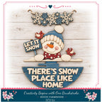 A wooden snowman holding a sign that says "LET IT SNOW" and a smaller sign that says "THERE'S SNOW PLACE LIKE HOME". The snowman is surrounded by snowflakes and birds, and the background is a wooden wall.