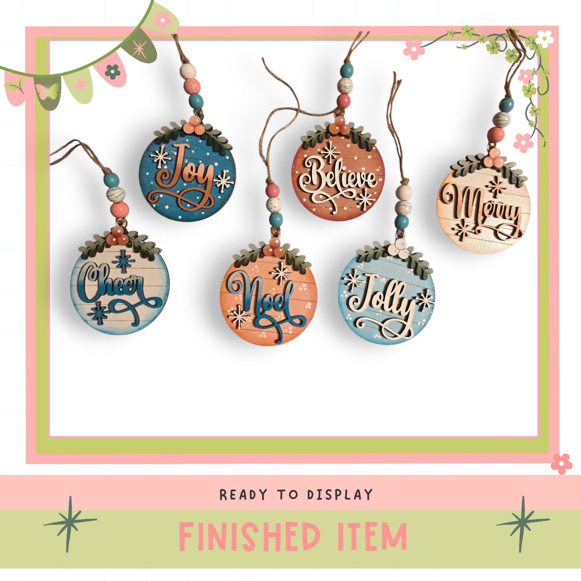 a collection of five wooden ornaments hanging from a string, each with a different word written on it. The words include "Joy", "Believe", "Merry", "Christmas", and "Noodle". The ornaments are arranged in a row, and the image includes a "Ready to Display" caption and a "Finished Item" caption at the bottom.