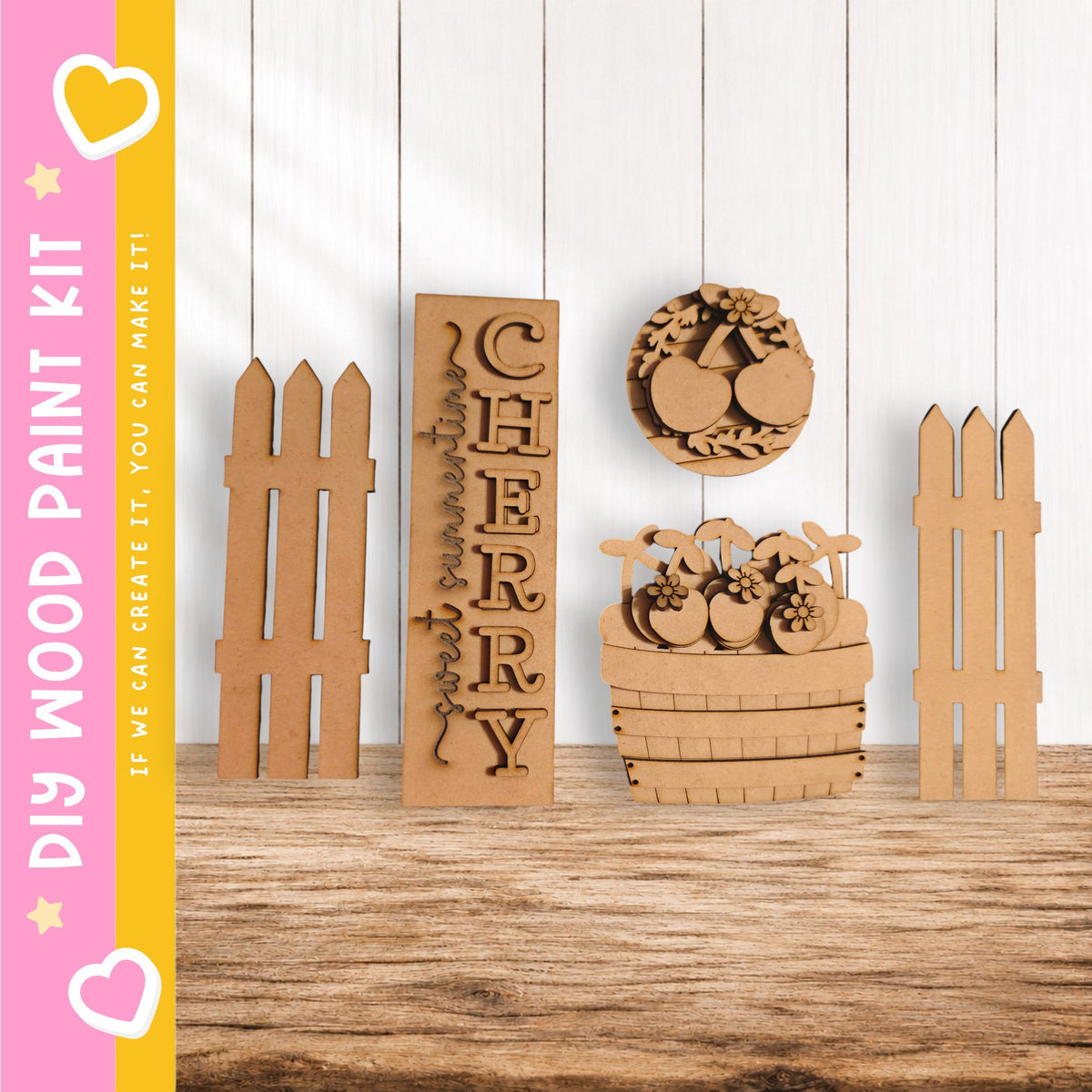 a collection of wooden cutouts, including a large wooden sign with the word "CHERRY" carved into it, a wooden fence, and a wooden basket filled with fruit. The objects are arranged on a wooden surface, creating a rustic and charming scene.